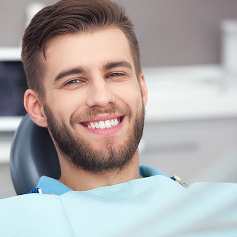 A man smiling after implants at Franklin Dental Services