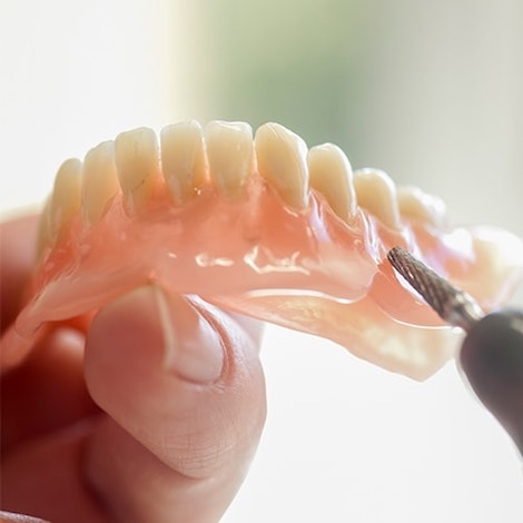 Dentures being held at Franklin Dental Services