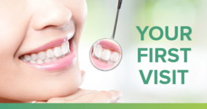 Woman smiling into dental mirror with the text, your first visit